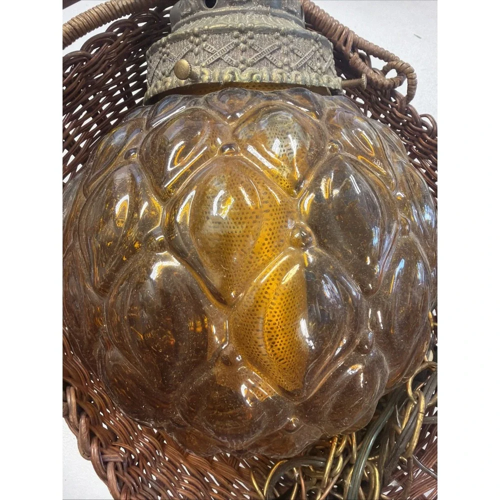 vintage mid-century modern hanging lamp features a distinctive amber glass globe
